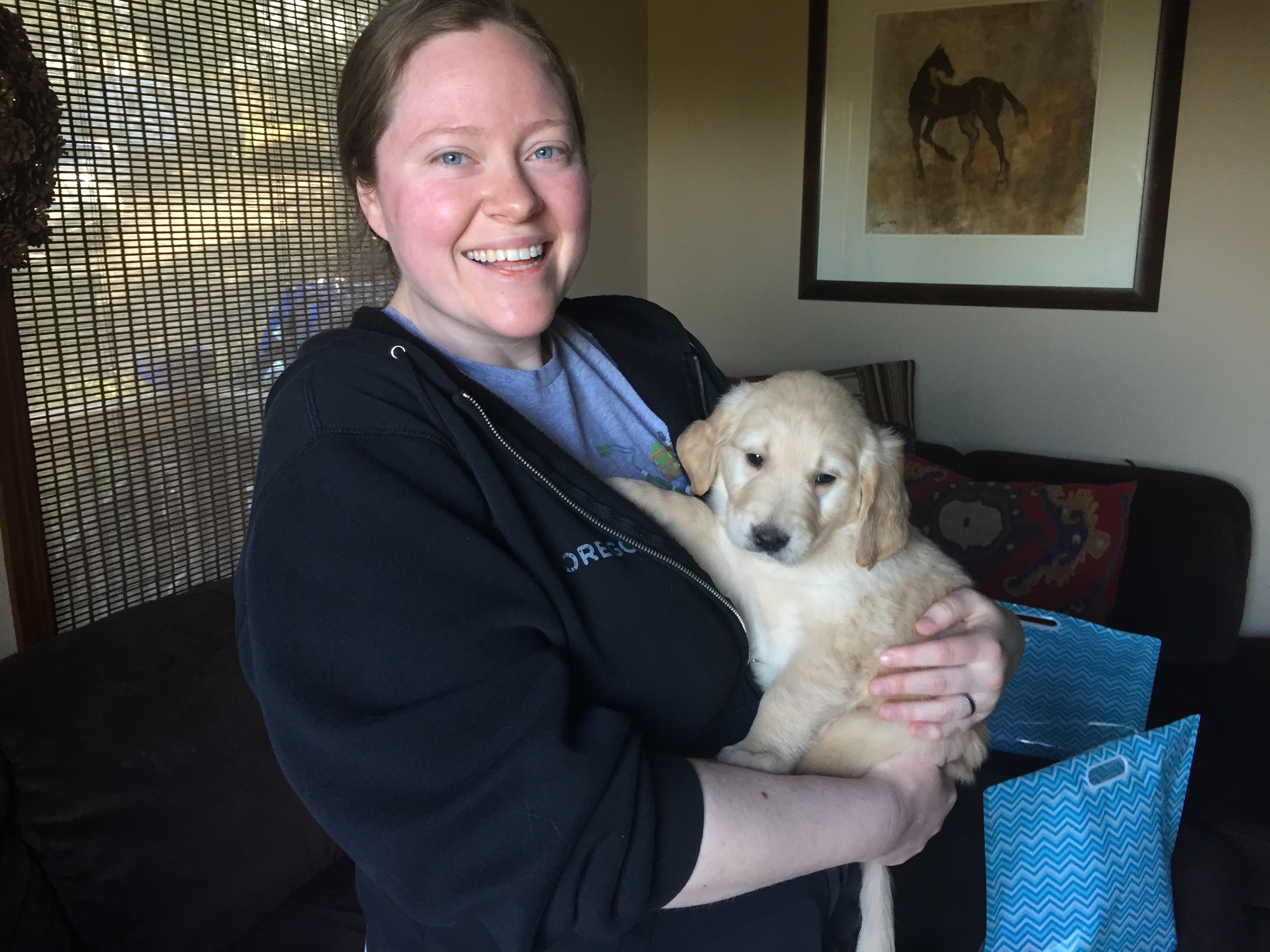 Bowser as a puppy held in his mother's arms